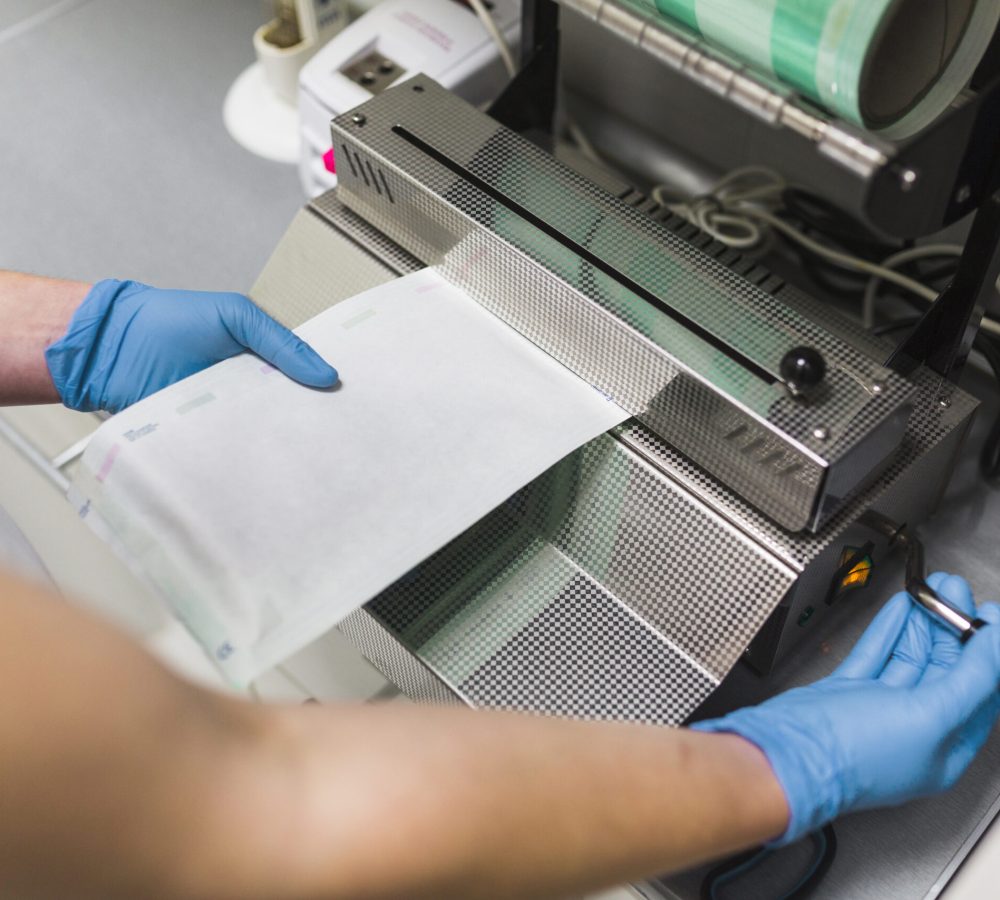 nurse-removing-plastic-from-pouch-sealer-packaging-machinery
