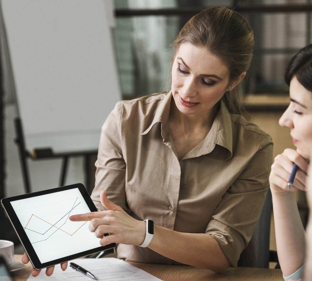 professional-businesspeople-using-tablet-meeting-indoors